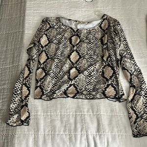 Animal print size small. Cute fit. A little cropped, but covers stomach